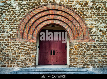 old vintage 1930's era church facade door and brick archway in suburban Paris Stock Photo