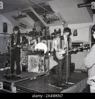1967, historical, young men from the band 'Hubbly Bubbly' playing music on a small stage, England, UK. Stock Photo