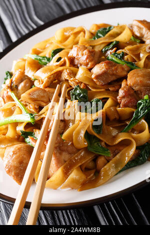 Pad See Ew – the popular Thai stir fried noodles closeup on the platr on the table. vertical Stock Photo