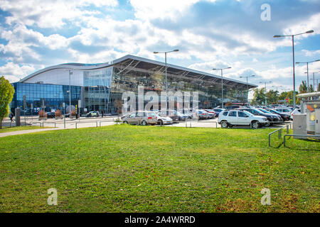 BRATISLAVA, SLOVAKIA – OCTOBER 6 2019: View of Bratislava Airport terminal with parking lot full of cars (Slovakia) Stock Photo