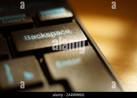 black keyboard on the sunny table closeup, selective focus on backspace key Stock Photo