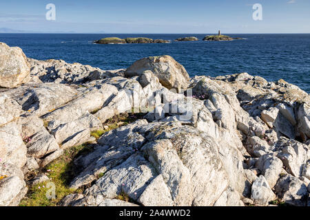 Rocky coastline and island at Rhoscolyn, Anglesey, North Wales on a sunny day Stock Photo