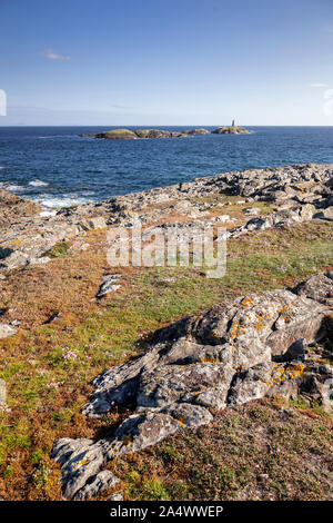 Rocky coastline and island at Rhoscolyn, Anglesey, North Wales on a sunny day Stock Photo