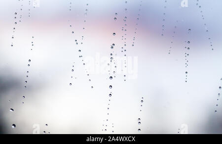 Bright wet window glass with droplets, rainy photo background texture with selective focus Stock Photo