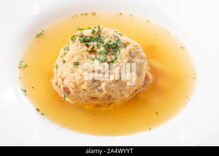 single speckknoedel in soup on wood Stock Photo