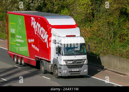 TK-Maxx, (TK Maxx); Bulk Haulage delivery trucks, haulage, lorry, transportation, truck, cargo, Mercedes Benz vehicle, delivery, transport, industry, supply chain freight, on the M6 at Lancaster, UK Stock Photo