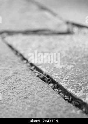 road surface made of natural wild stone closeup, bw photo Stock Photo
