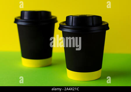 Black coffee cup to take away on colorful background. Mock up. Stock Photo