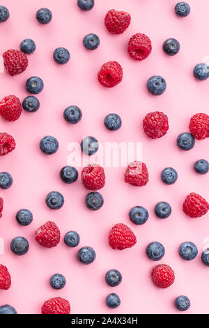 Blueberries and raspberries. Tasty mix of berries on pink background. Stock Photo
