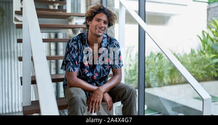Attractive brazilian hipster millennial man looking into camera Stock Photo