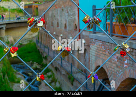Heart shaped Love padlocks on metal wire. Stock Photo