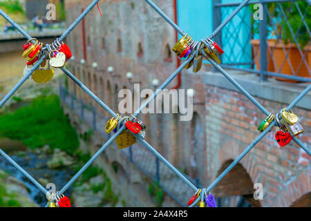 Heart shaped Love padlocks on metal wire. Stock Photo