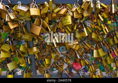 Close up old rusty Love padlocks on metal wire. Stock Photo