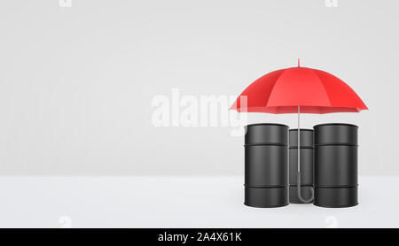 An open classic red umbrella with a handle vertically placed over black oil barrels. Stock Photo