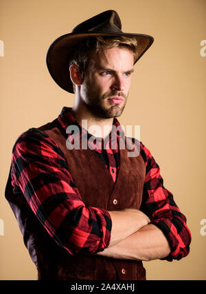 wanted. western cowboy portrait. man checkered shirt on ranch. Vintage style man. Wild West retro cowboy. cowboy in country side. Western. wild west rodeo. Handsome man in hat. Stock Photo