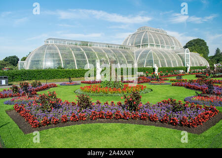Palm House at Kew Gardens with flower display in full bloom with no people in view, Royal Botanic Gardens, Kew, London, England Stock Photo