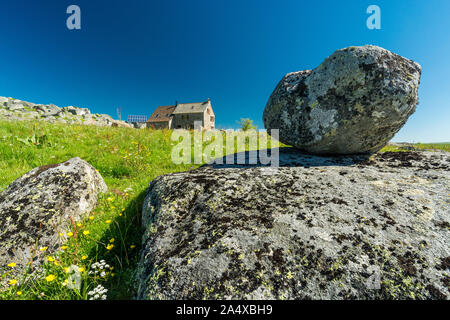 Stone and granite rock near a house on the Aubrac plateau Stock Photo