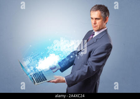 Man holding laptop projecting notifications, symbols and information based on cloud technology system Stock Photo
