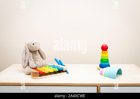 Background of Colorful Children's toys against the wall Toys on Wood Table with Copy Space for Text Stock Photo