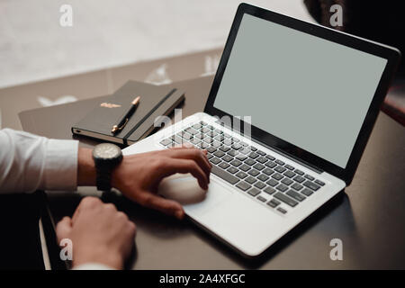 Man using, working on laptop with white screen. startup Stock Photo
