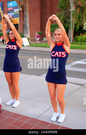 Cheerleaders from the University of Arizona Wildcats practice their routine on the sidewalk at UA in Tucson Stock Photo