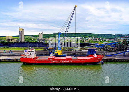 River Seine La Havre area Rouen August 14 2019  bulk carrier Velserdijk being loaded by crane with coal Stock Photo