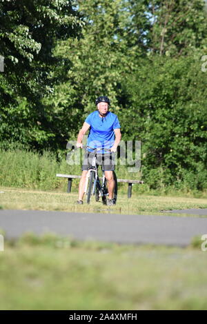 Lonely Male Cyclist Wearing Helmet Riding Bike Stock Photo