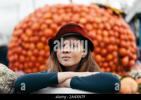 A red-haired teenage girl in retro hat with freckles on a pretty face Stock Photo
