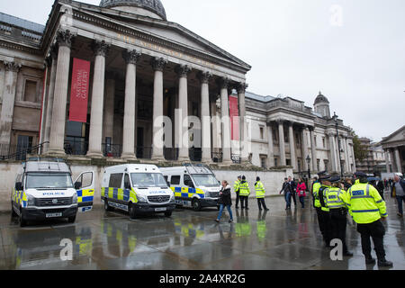 London, UK. 16 October, 2019. Police officers and vehicles stand in Trafalgar Square following a Metropolitan Police prohibition on Extinction Rebellion Autumn Uprising protests throughout London under Section 14 of the Public Order Act 1986. Credit: Mark Kerrison/Alamy Live News Stock Photo