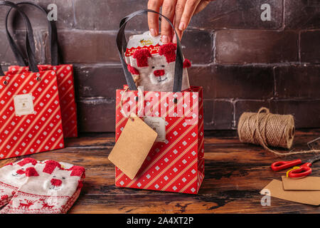 Gift boxes wrapped in red checked paper. Valentines day, Christmas, New year gift packing. Holiday decor concept. Stock Photo