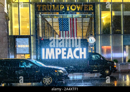 New York, USA,  16 October  2019.  A truck displays a large luminous IMPEACH sign as it drives through New York City's Fifth Avenue in front of  the Trump Tower under pouring rain.  Democrats began an impeachment inquiry of President Donald Trump last week. Credit: Enrique Shore/Alamy  Live News Stock Photo