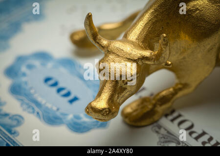 Gold Bull on Blue Stock Certificate  Close Up. Stock Photo