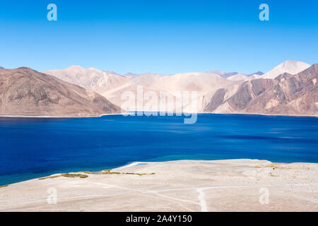 Landscape image of Pangong lake with mountains view and blue sky background Stock Photo