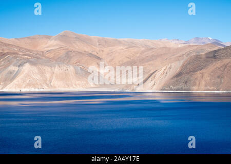 Landscape image of Pangong lake with mountains view and blue sky background Stock Photo