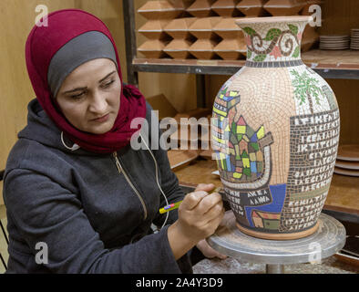 Petra, Jordan - 2019-04-20 - Woman creates intricate mosaic vase. Stock Photo