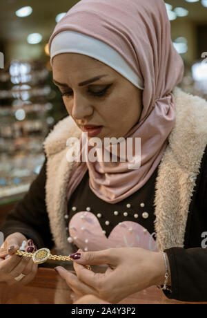 Petra, Jordan - 2019-04-20 - Woman shows off intricately decorated watch for sale. Stock Photo