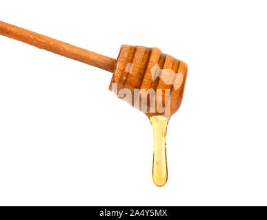 Fresh honey dripping from a honey dipper isolated on white background, bee products by organic natural ingredients concept Stock Photo