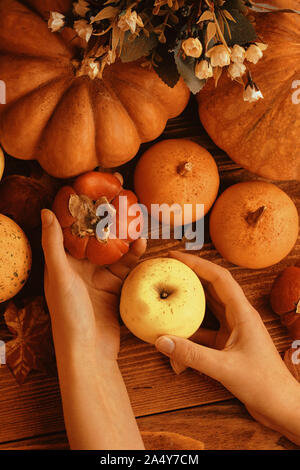 A bunch of pumpkins and apples. Thanksgiving dinner. Autumn fruit with plate and cutlery. Thanksgiving autumn background Stock Photo