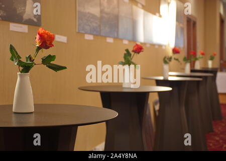 Red roses in white vase on the table Stock Photo