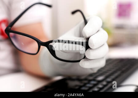 Picture of man typing with keyboard and wearing hand gloves. Isolated on white background. Stock Photo