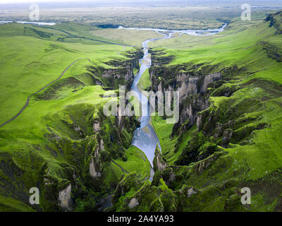 Unique rugged landscape of Fjaðrárgljúfur canyon covered by beautiful green moss, located in southern Iceland. Aerial shot. Stock Photo