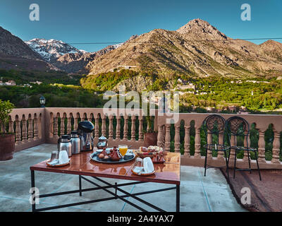 Traditional moroccan breakfast setting with mountain view in the background in Imlil, Morocco, High Atlas mountains Stock Photo