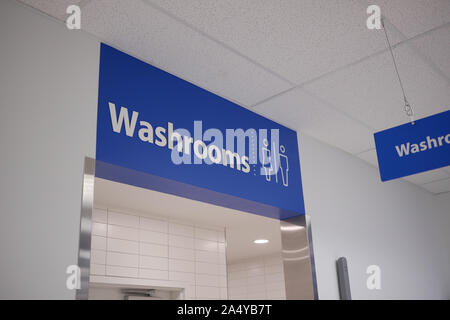 Motion of man and woman washroom logo on wall Stock Photo