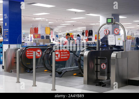 Motion of people taking escalators in modern urban interior inside Walmart store Stock Photo