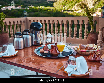 Close up shot of traditional moroccn breakfast consisting of mint tea, coffee, eggs, home made arabic bread, fresh home made orange juice Stock Photo