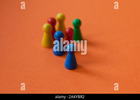 game pieces from fia with a push, the pieces can also represent people with different backgrounds Stock Photo