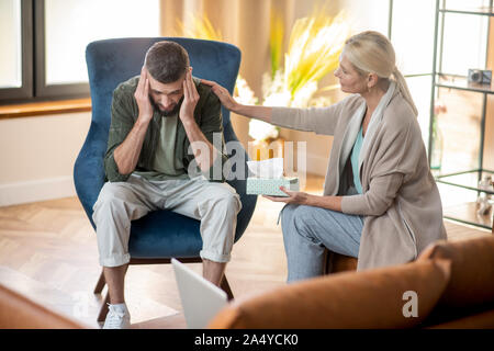 Psychoanalyst supporting client who feeling very depressed Stock Photo