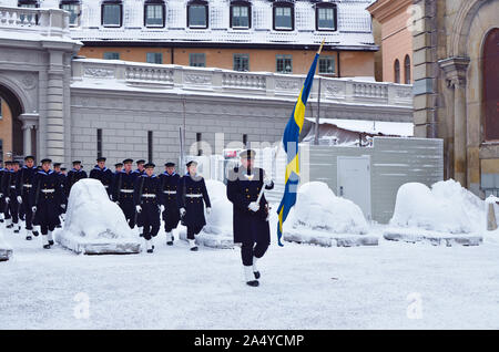 STOCKHOLM, SWEDEN - FEBRUARY 03, 2019: The exit of soldiers and officers with weapons and a flag to protect the royal presidential palace is made in a Stock Photo