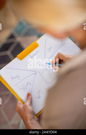 Psychoanalyst writing down while making the investigation Stock Photo