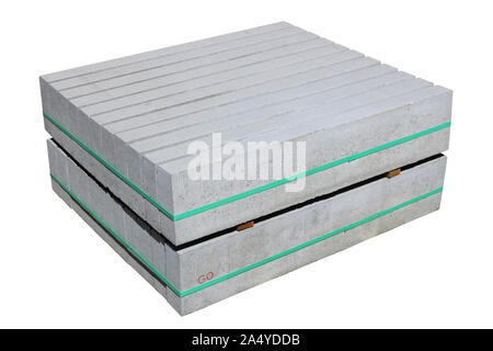 The new long rectangular concrete curb road  blocks of a rectangular shape are pulled together by a green plastic tape.  Isolated on white Stock Photo